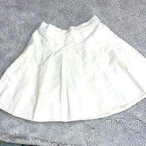 White pleaded mini tennis skirt.